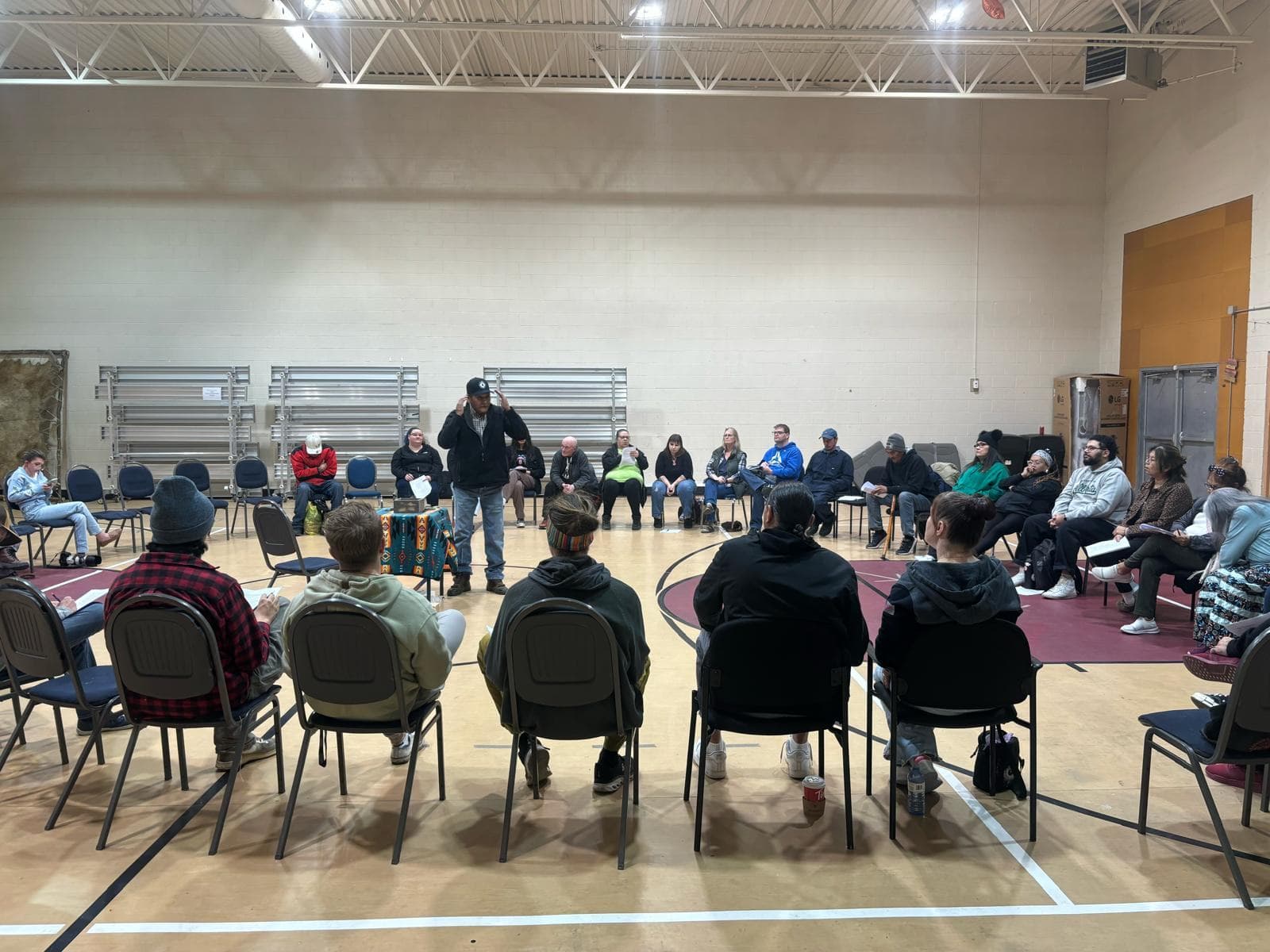 A community sharing circle in a gymnasium